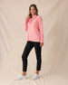 Misty Top in Spritz, full length front view featuring a solid pink waffle knit pullover with cowl neck and drawstring detail, paired with black ankle pants and white golf shoes