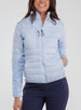 Straight Down Women's Pines Jacket in Powder, front model view showing light blue quilted body with stand collar, chest zip pocket, and full zip closure paired with navy pants