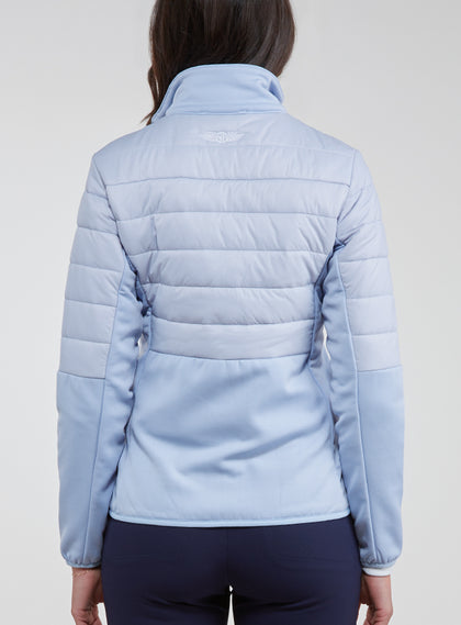 Straight Down Women's Pines Jacket in Powder, rear model view showing light blue quilted back with stretch side panels and Straight Down logo at upper back