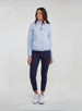 Straight Down Women's Pines Jacket in Powder, full length model view showing light blue quilted jacket paired with navy pants and white golf shoes
