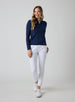 Straight Down Women's Celeste Jacket in Indigo, full length front view on model featuring a navy full-zip jacket with mock neck collar, paired with white pants and white shoes