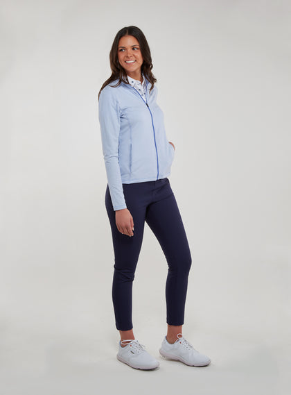 Straight Down Women's Celeste Jacket in Lavender, full length side view on model featuring a light purple full-zip jacket with contrasting blue zipper, paired with navy pants and white shoes