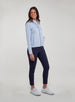 Straight Down Women's Celeste Jacket in Lavender, full length side view on model featuring a light purple full-zip jacket with contrasting blue zipper, paired with navy pants and white shoes