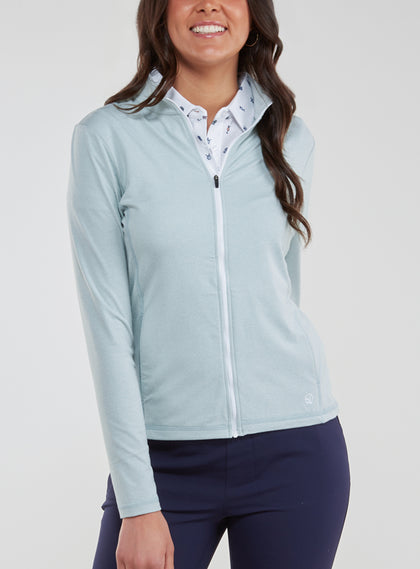 Straight Down Women's Celeste Jacket in Mineral, front view on model featuring a light sage green full-zip jacket with white zipper, paired with navy pants