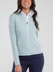Straight Down Women's Celeste Jacket in Mineral, front view on model featuring a light sage green full-zip jacket with white zipper, paired with navy pants