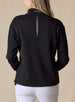 Women's Opal Half Zip in Black, back view on model featuring a black waffle-textured pullover with an embroidered logo at the collar and a center back vent detail paired with white pants