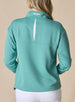Women's Opal Half Zip in Sea Green, back view on model featuring a sea green waffle-textured pullover with an embroidered Straight Down logo at the collar and a white center back vent detail paired with white pants