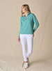 Women's Opal Half Zip in Sea Green, full front view on model featuring a sea green waffle-textured pullover with a quarter-zip neckline paired with white pants and white golf shoes