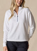 Women's Opal Half Zip in White, front view on model featuring a white waffle-textured pullover with a quarter-zip neckline and contrast navy zipper paired with black pants