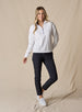 Women's Opal Half Zip in White, full front view on model featuring a white waffle-textured pullover with a quarter-zip neckline paired with black pants and white golf shoes