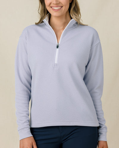 Woman wearing the Straight Down Opal Half Zip in Cosmic Blue, front view