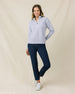 Woman wearing the Straight Down Opal Half Zip in Cosmic Blue paired with navy golf pants