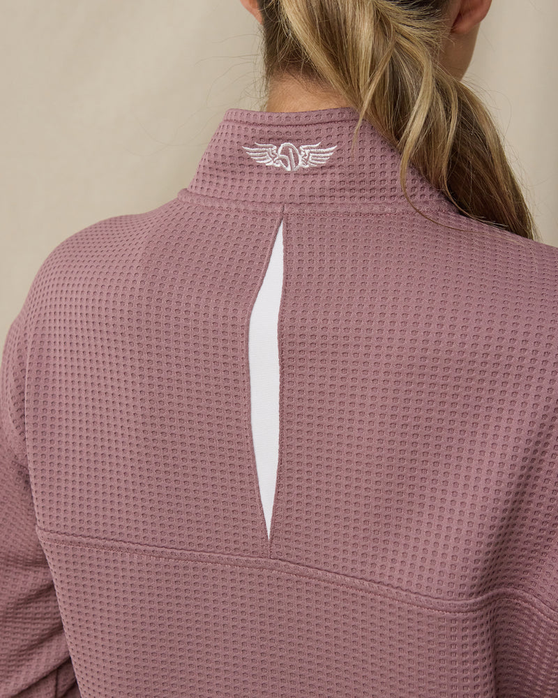 Close-up of the Straight Down Opal Half Zip in Oxblood Red highlighting the vented back opening and embroidered logo at the mock neck collar