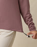 Close-up of the Straight Down Opal Half Zip in Oxblood Red highlighting the adjustable drawcord hem and textured waffle knit fabric