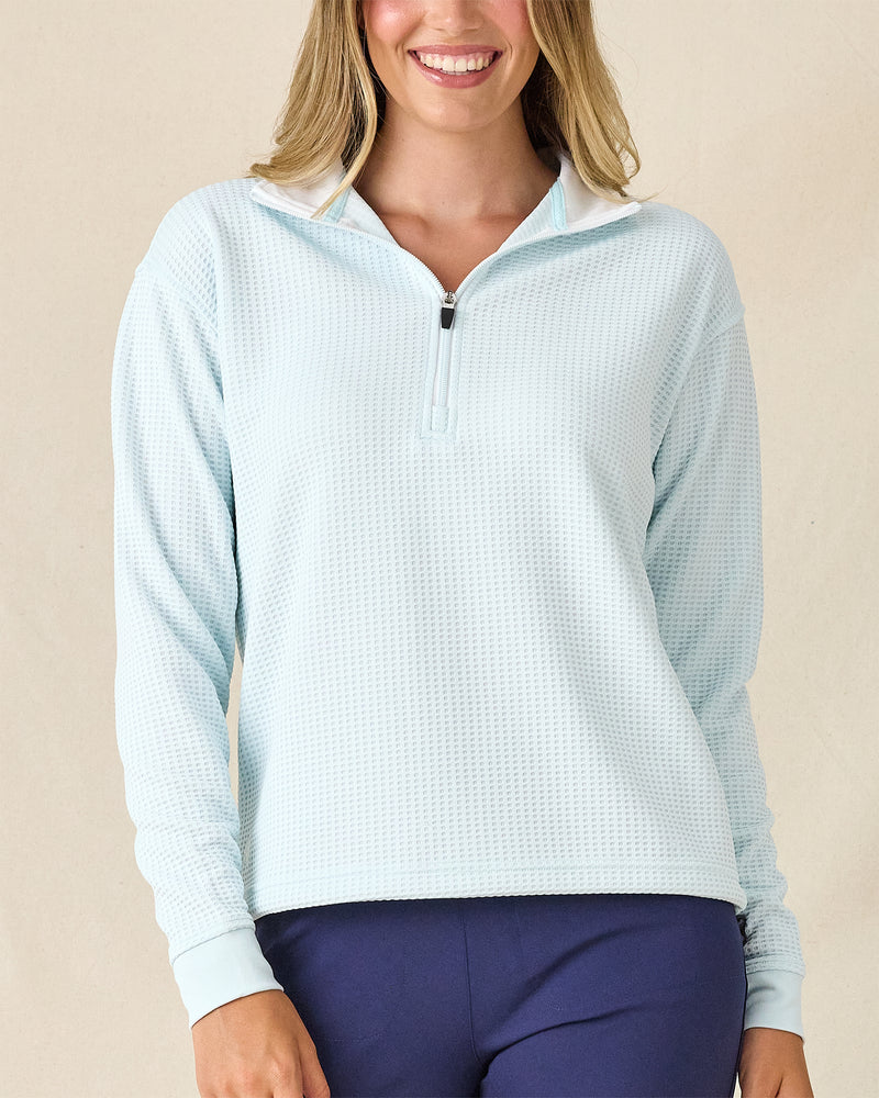 Opal Half Zip in Sea Spray, front view featuring a light blue and white waffle knit pullover with quarter zip and white contrast collar lining, paired with navy pants