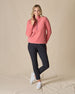 Women's Cerro Quarter Zip in Cedar, full length front view on model featuring a coral fleece quarter zip pullover with purple zipper accents, paired with black pants and white golf shoes