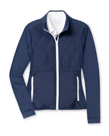 Women's Hera Jacket in New Indigo, flat lay front view featuring a hybrid construction with a quilted diamond-pattern navy front body and solid navy stretch sleeves, full zip white closure, stand-up collar, and zip side pockets with white contrast trim, layered over a white collared shirt