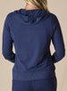 Women's Mesa Hooded Jacket in New Indigo, back model view featuring a navy full-zip hoodie with drawstring hood, clean back panel, ribbed hem, and long sleeves paired with matching pants
