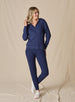 Women's Mesa Hooded Jacket in New Indigo, full length model view featuring a navy full-zip hoodie with drawstring hood paired with matching pants and white athletic shoes