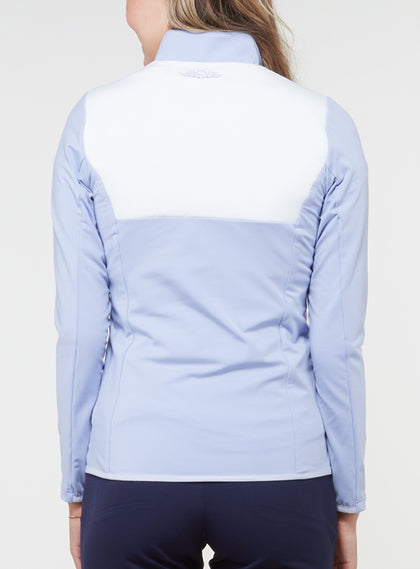 Women's Althea Half Zip in Lavender, back view on model featuring a color-blocked white upper back panel with soft lavender blue knit lower body and sleeves, and a tonal Straight Down logo at the upper back, paired with navy pants