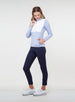 Women's Althea Half Zip in Lavender, full-length front view on model featuring a color-blocked white quilted front panel with soft lavender blue knit sleeves and lower body, with hand in zippered side pocket, paired with navy pants and white shoes