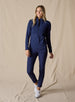 Women's Althea Half Zip in New Indigo, full-length front view on model featuring a tonal navy lightly quilted front panel with navy knit sleeves and lower body, paired with matching navy pants and white shoes