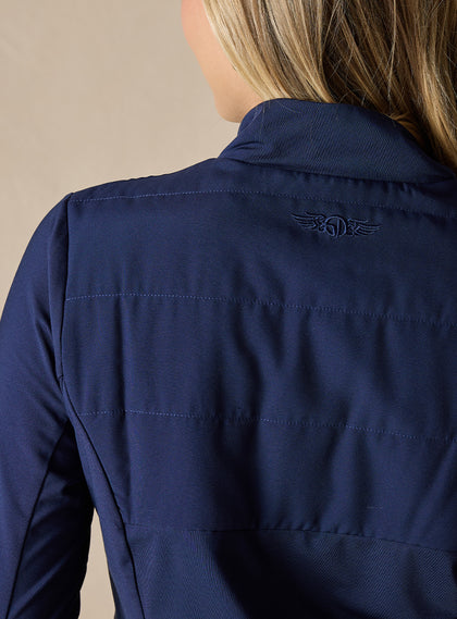Women's Althea Half Zip in New Indigo, close-up back detail view featuring the tonal navy lightly quilted upper back panel with tonal Straight Down logo and horizontal stitch detailing