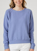Delia Sweatshirt in Blueberry, front view on model featuring a medium blue ribbed-texture crewneck pullover with raglan sleeves and ribbed hem styled with white pants