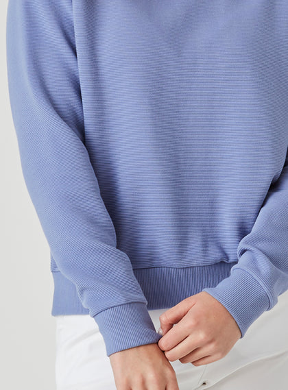 Delia Sweatshirt in Blueberry, close-up detail view featuring the horizontal ribbed texture of the fabric and ribbed knit cuff detail