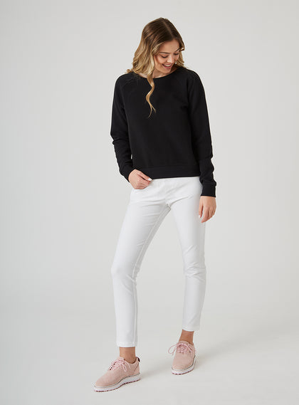 Delia Sweatshirt in Black, full length front view on model featuring a black ribbed-texture crewneck pullover with raglan sleeves and ribbed hem styled with white pants and pink shoes