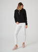 Delia Sweatshirt in Black, full length front view on model featuring a black ribbed-texture crewneck pullover with raglan sleeves and ribbed hem styled with white pants and pink shoes