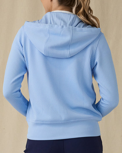 Eliza Hoodie in Carolina, back view on model showing a light blue waffle-knit full zip hoodie with drawstring hood, paired with navy pants