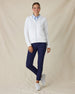 Eliza Hoodie in White, full length front view on model showing a white waffle-knit full zip hoodie with drawstring hood, layered over a light blue polo, paired with navy pants and white golf shoes