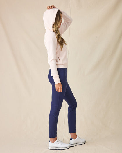 Eliza Hoodie in Pearl, full length front view featuring a blush pink waffle knit full zip hoodie, layered over a white polo and paired with navy ankle pants and white golf shoes