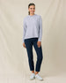 Woman wearing the Daria Hoodie in Cosmic Blue with navy golf pants