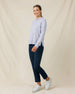 Woman wearing the Straight Down Daria Hoodie in Cosmic Blue with navy golf pants, side view