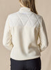 Women's Laurel Hybrid Fleece Jacket in Cream, back view on model featuring a cream quilted upper body with fleece lower body and sleeves, full-zip closure, and side zip pockets paired with black pants