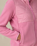 Women's Laurel Hybrid Fleece Jacket in Sweet Rose, detail close-up view featuring the diamond quilted upper body panel, fleece lower body and sleeve construction, full-zip closure, and zippered side pocket with model's hand inside pocket