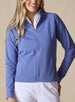 Women's Eirene Jacket in Blueberry, front view on model featuring a solid cornflower blue performance fabric with a full-zip stand collar and raglan sleeves, with zippered side pocket detail, layered over a white polo and paired with white pants