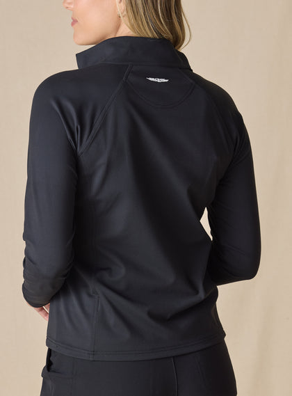 Women's Eirene Jacket in Black, back view on model featuring a solid black performance fabric with raglan sleeve construction and white Straight Down logo at the upper back, paired with black pants