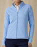 Women's Eirene Jacket in Carolina, front view on model featuring a light blue full-zip jacket with mock neck collar, raglan sleeves, and zippered side pockets, paired with navy pants