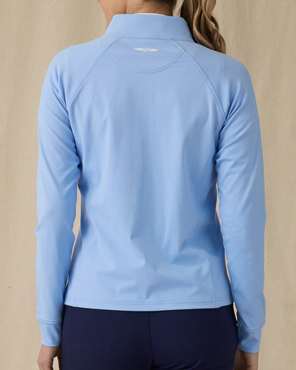 Women's Eirene Jacket in Carolina, back view on model featuring a light blue full-zip jacket with Straight Down logo at upper back, raglan sleeve construction, and curved hem, paired with navy pants