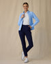 Women's Eirene Jacket in Carolina, full length front view on model featuring a light blue full-zip jacket with mock neck collar worn open over a white polo, paired with navy pants and white golf shoes