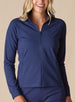 Women's Eirene Jacket in New Indigo, front view on model featuring a solid navy performance fabric with a full-zip stand collar and raglan sleeves, with zippered side pocket detail, paired with matching navy pants