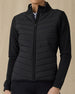Women's Ida Hybrid Jacket in Black, front view on model featuring a black full zip jacket with a quilted front body panel and smooth stretch sleeves, paired with black pants