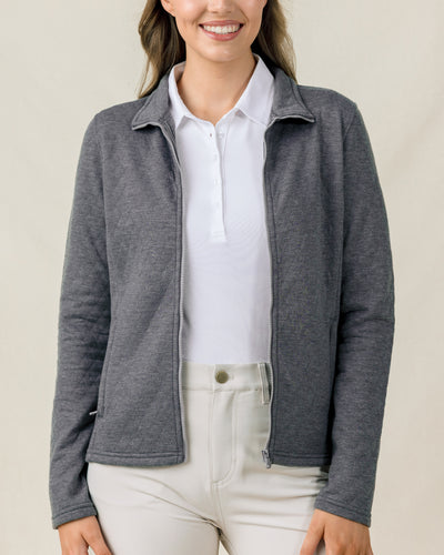 Front view of a model wearing the Marlow Jacket in Nightshade open over a white polo with light-colored pants.