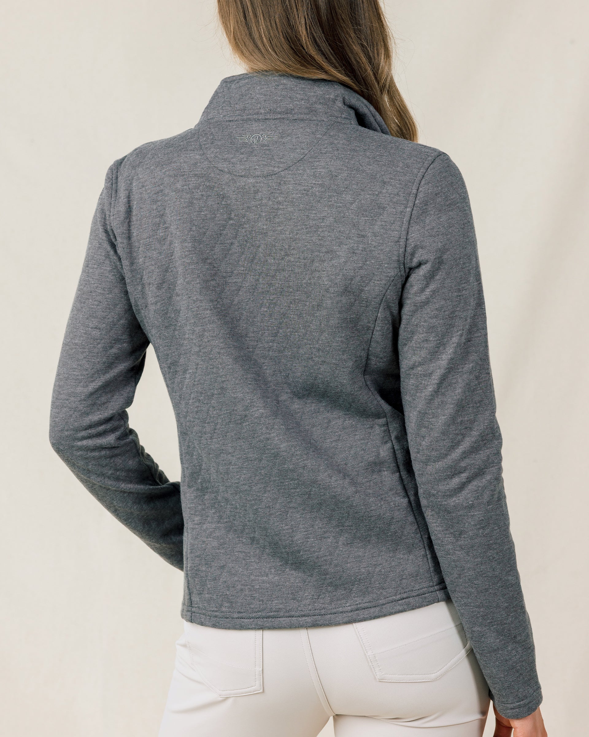 Back view of a model wearing the Marlow Jacket in Nightshade, showing the fitted silhouette and embroidered logo below the collar.