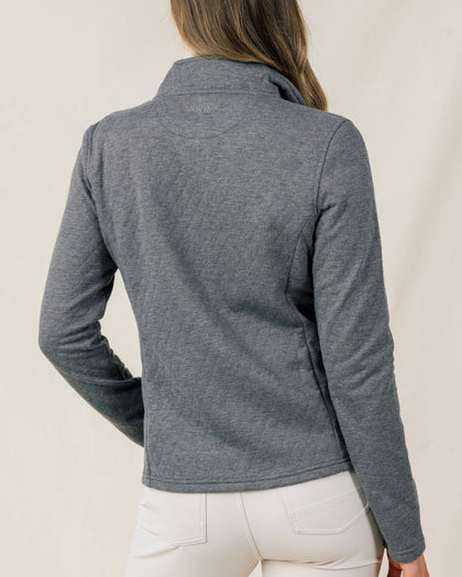 Back view of a model wearing the Marlow Jacket in Nightshade, showing the fitted silhouette and embroidered logo below the collar.
