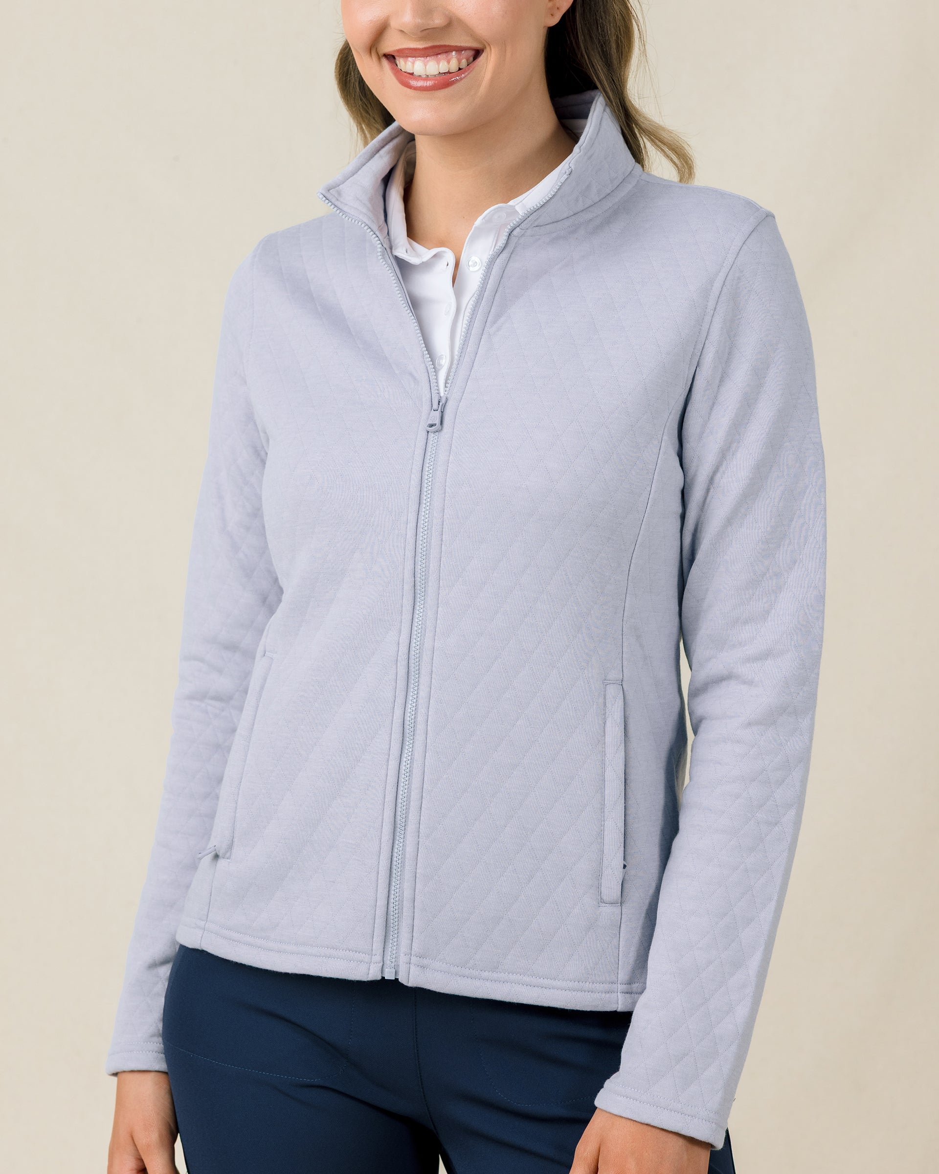 Woman wearing the Marlow Jacket in Cosmic Blue fully zipped with a quilted design