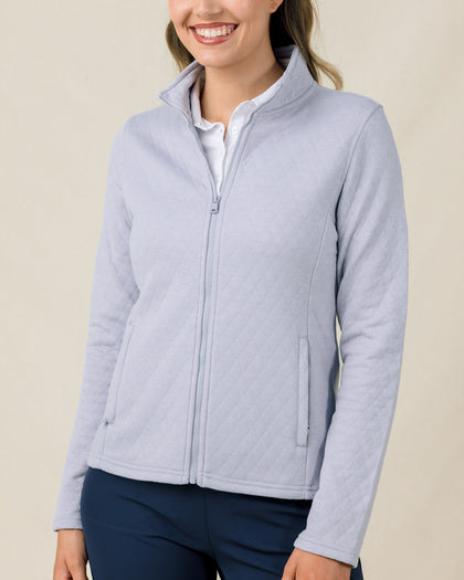 Woman wearing the Marlow Jacket in Cosmic Blue fully zipped with a quilted design